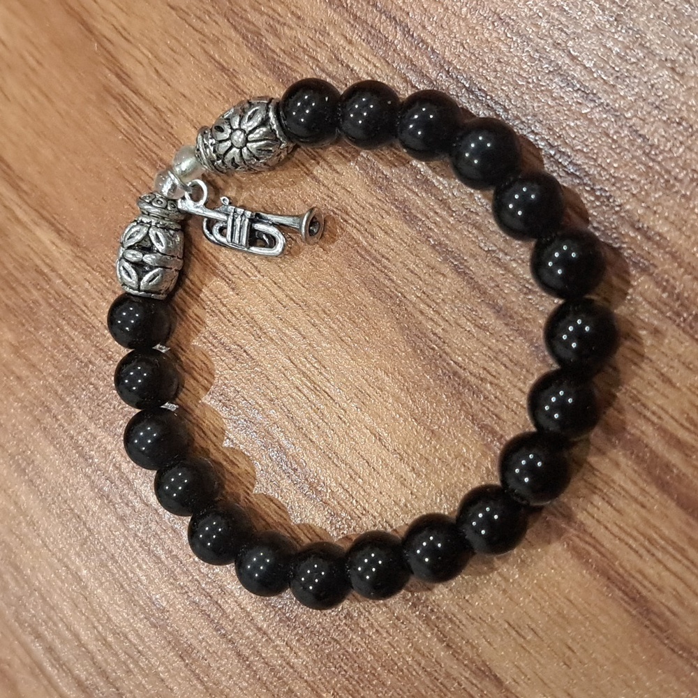 Black beaded bracelet with trumpet charm